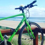 green bike near beach and ocean